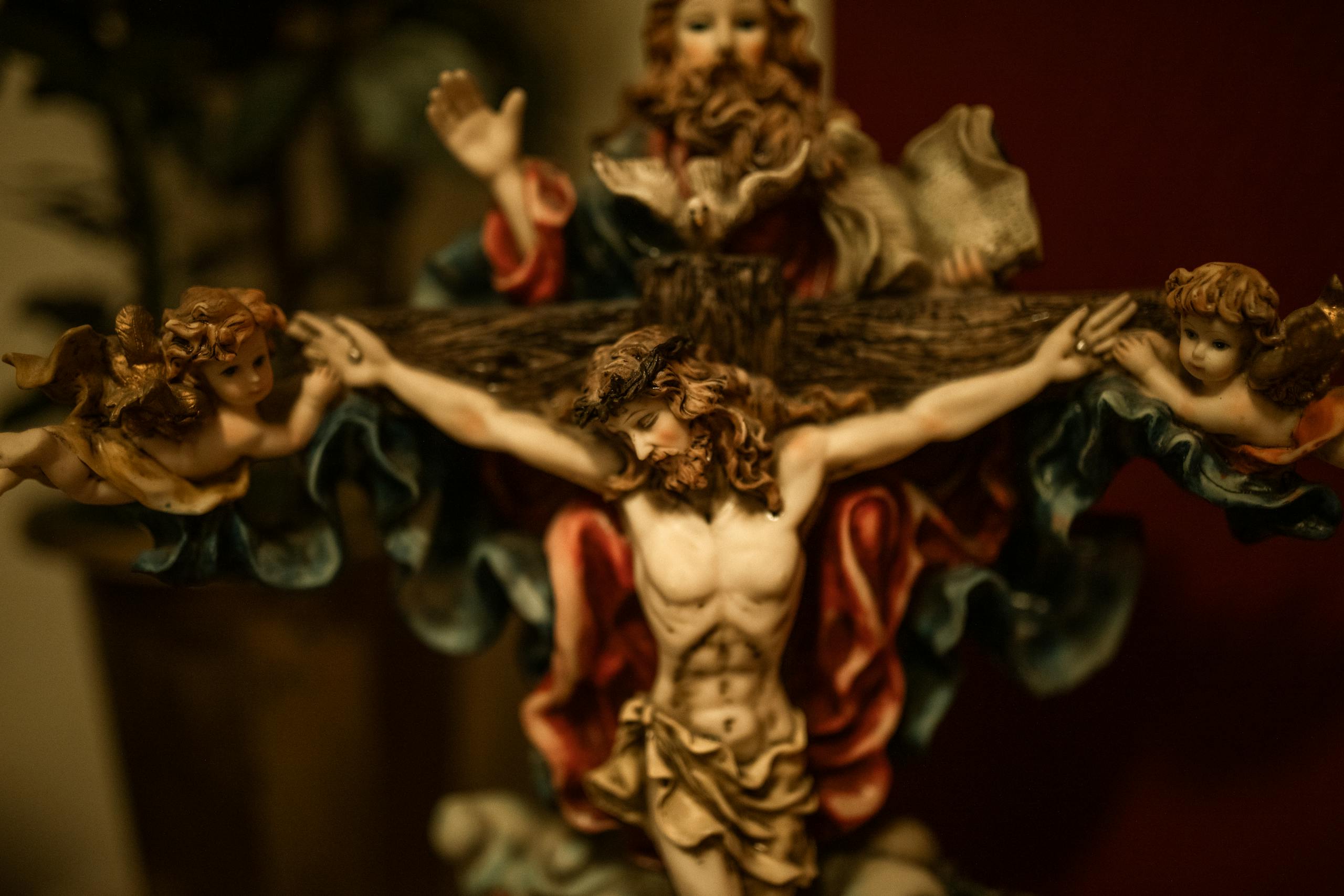 Close-up of a religious sculpture depicting Jesus Christ and angels in an artistic setting.
