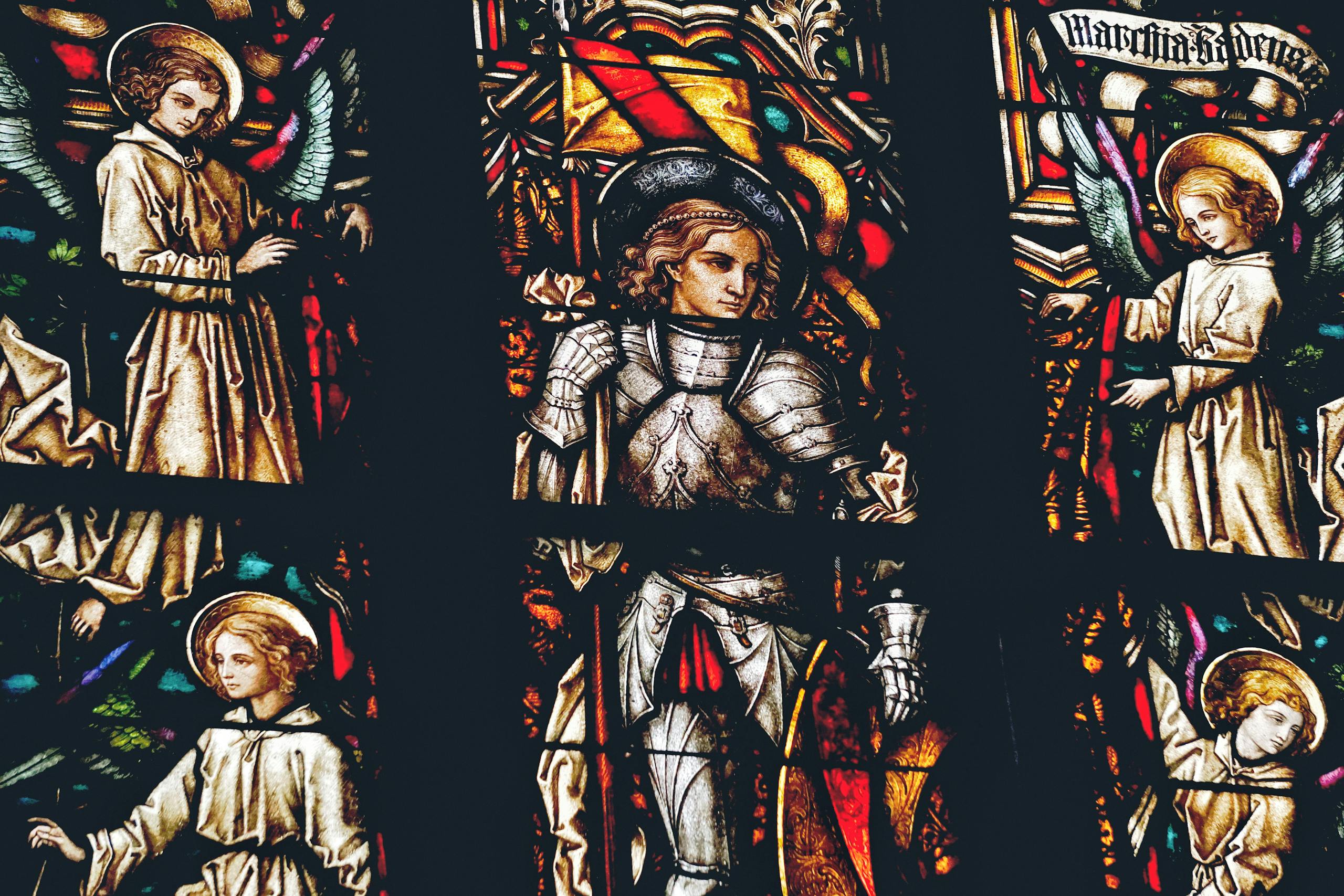 Beautiful stained glass depicting biblical scenes inside a Gothic cathedral.